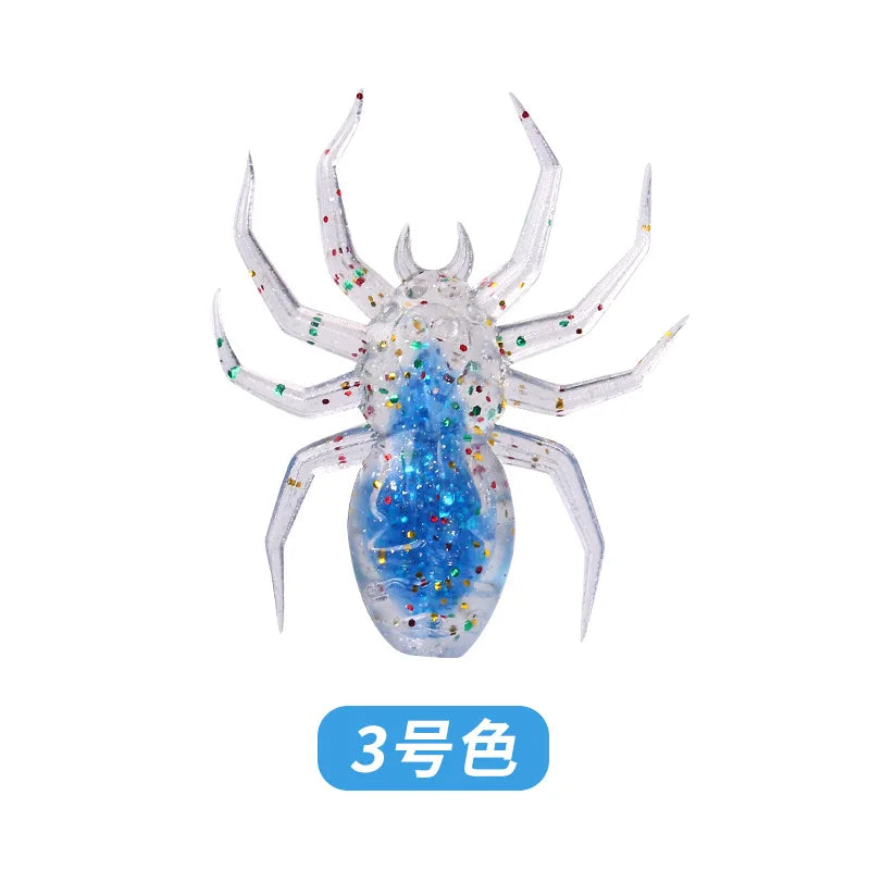 A realistic, laser-reflective flexible fishing lure shaped like a spider, featuring blue and iridescent glitter.