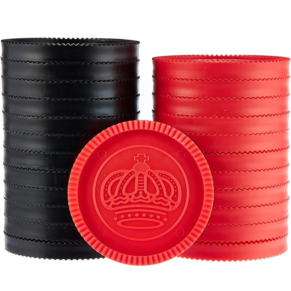 A set of black and red plastic checkers and tic tac toe game pieces displayed on a white background.