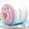 A roll of gradient rainbow yarn with pink, purple, and white colors shown on a light blue background.
