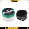 A jar of rosin for string instruments with a black lid and a separate piece of dark green rosin.