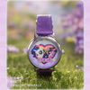 A purple watch featuring a Friends design on the face, set in a natural outdoor context.