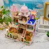 A detailed wooden dollhouse kit of a castle with pink and white architecture, featuring LED lighting and furniture.