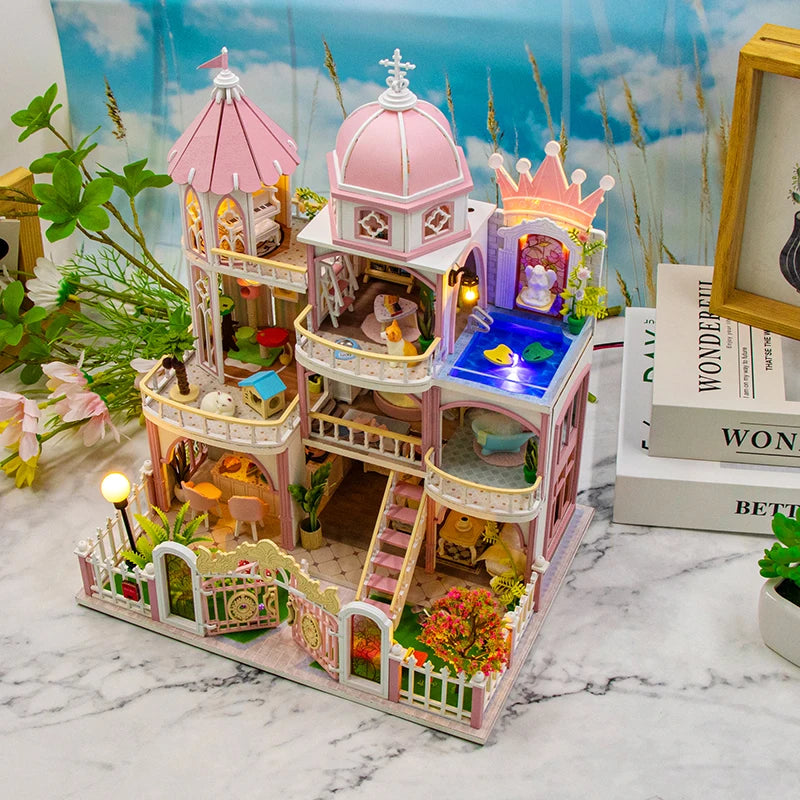 A detailed wooden dollhouse kit of a castle with pink and white architecture, featuring LED lighting and furniture.