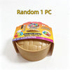 A single unicorn dumpling squishy stress ball is shown in its bamboo steamer box.