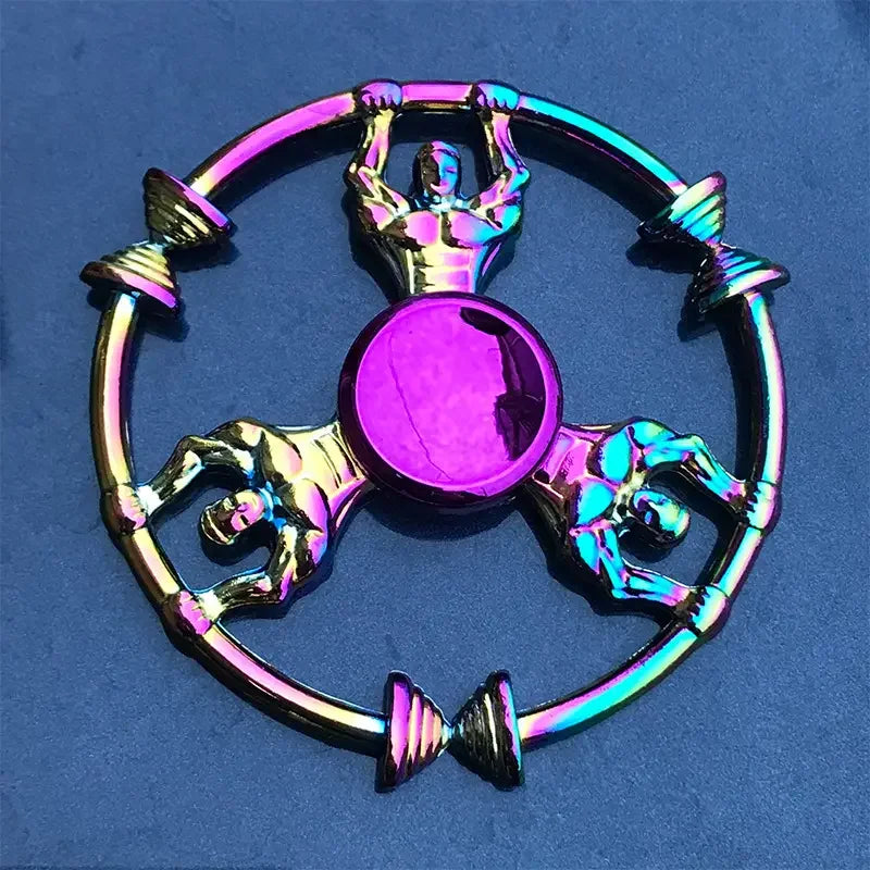 A colorful metal fidget spinner featuring a central disc and four figure components, displayed against a blue background.