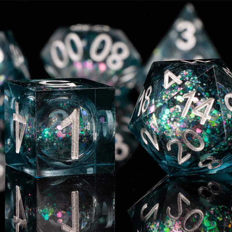 A close-up shot of a set of translucent teal dice, including a d10 and a d20, reflecting on a dark surface.