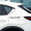 A white car with a black roof spoiler features the GUTS letter waterproof vinyl sticker on the side panel.