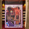 A display featuring a DIY tarot book nook kit with intricate details and LED lighting set within an ornate frame.