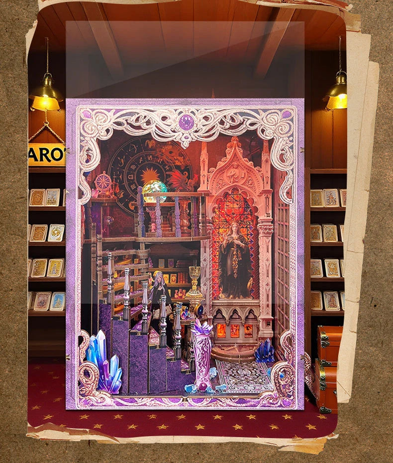 A display featuring a DIY tarot book nook kit with intricate details and LED lighting set within an ornate frame.