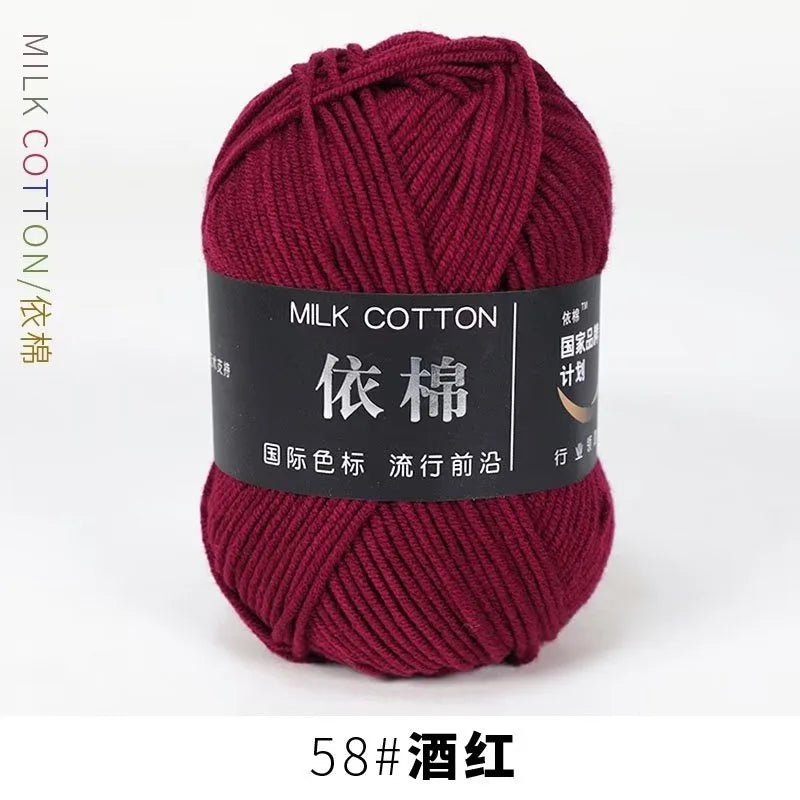 A skein of dark maroon milk cotton yarn labeled 58# in wine red color.