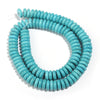 A strand of natural turquoise stone beads coiled into a loop for jewelry making