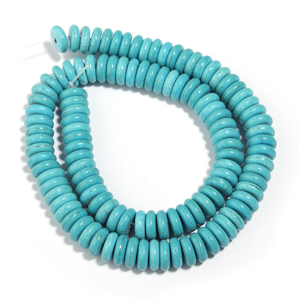 A strand of natural turquoise stone beads coiled into a loop for jewelry making