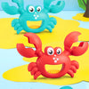 A set of soft color matching toys featuring a blue crab claw and green dinosaur digging tools on a light blue background.