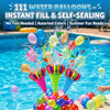 A close-up of water balloons being thrown and splashing in a swimming pool with many colorful balloons floating on the surfac