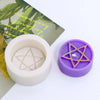 A purple silicone mold shaped like a pentagram is shown next to a white cylindrical mold and green leaves.