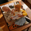 A jigsaw puzzle featuring a photo of an elderly woman wearing an orange sweater and looking at a younger person.