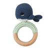 A blue otter shaped wooden baby rattle and teether ring with a white trim.