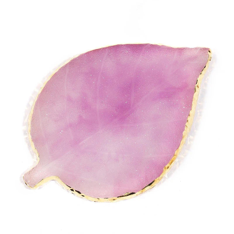 A translucent pink resin nail art palette with a gold trim.