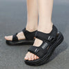 A pair of black Onedge boys' non-slip summer sport sandals worn by a person.