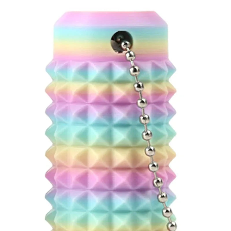 A stack of colorful, spiky fidget key charms in pastel shades of pink, blue, and green.