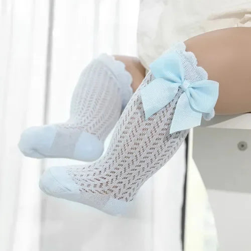 Light blue lace knee socks for a baby girl with a decorative bow