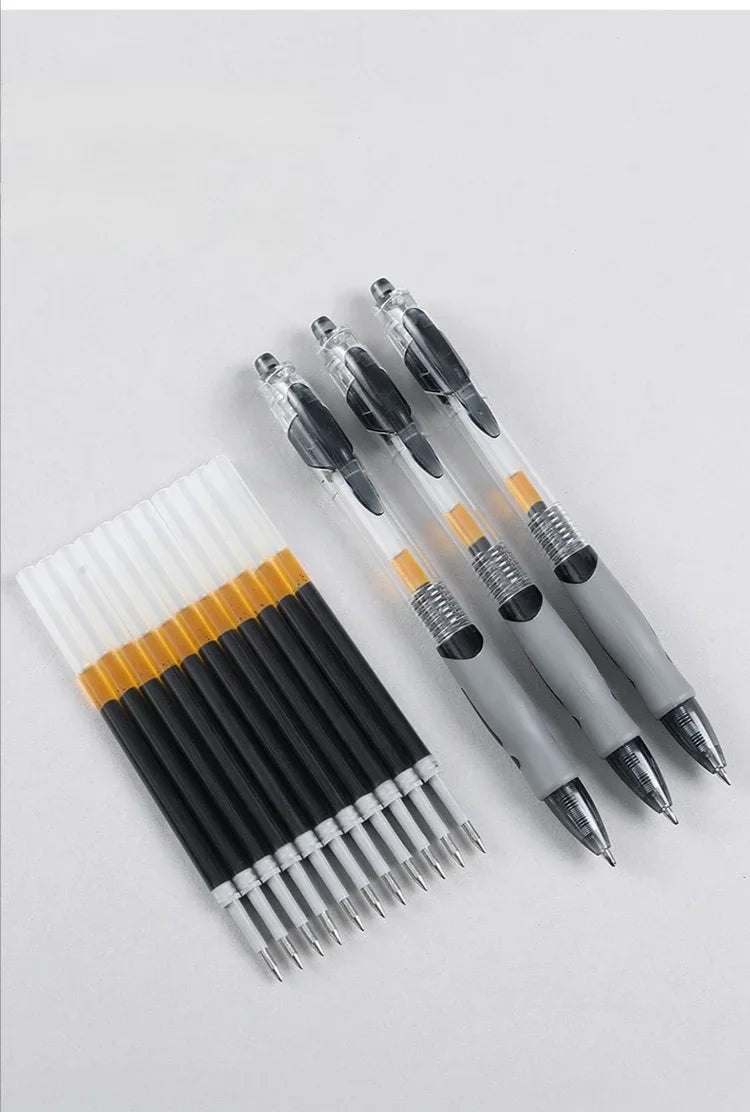 A collection of black and silver retractable gel pens with gold accents arranged diagonally on a white surface.