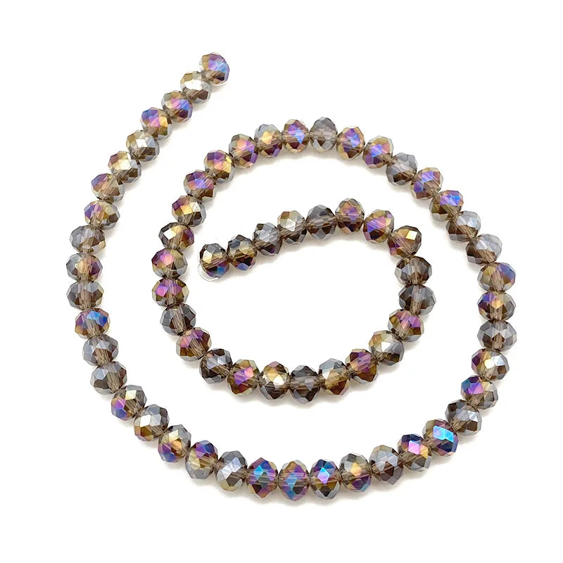 A strand of faceted crystal beads in various shades of brown and amber used for jewelry making.