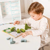 A toddler is playing with a wooden animal threading and stacking toy set on a white table.