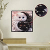 Diamond painting artwork of a Yin Yang cat, featuring white and black patterns, displayed on a wall.