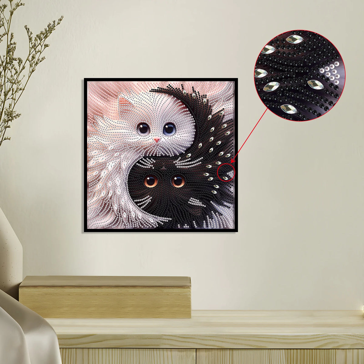 Diamond painting artwork of a Yin Yang cat, featuring white and black patterns, displayed on a wall.