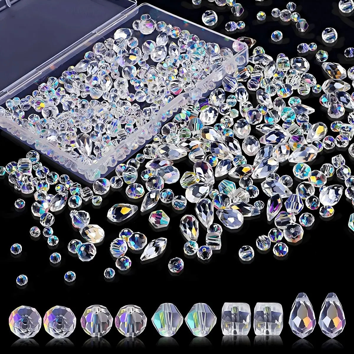 A collection of clear crystal glass beads and stones in various shapes and sizes, including a plastic container and loose bea