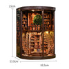 A dark wood book nook kit featuring detailed bookshelves and a miniature tree with internal LED lighting.