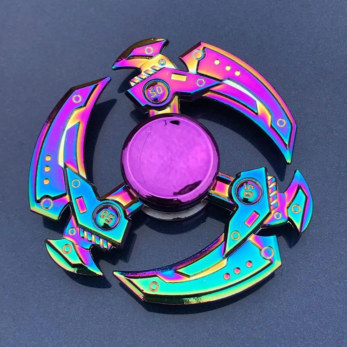 A shiny purple and silver metal fidget spinner with a smooth rotating blade.