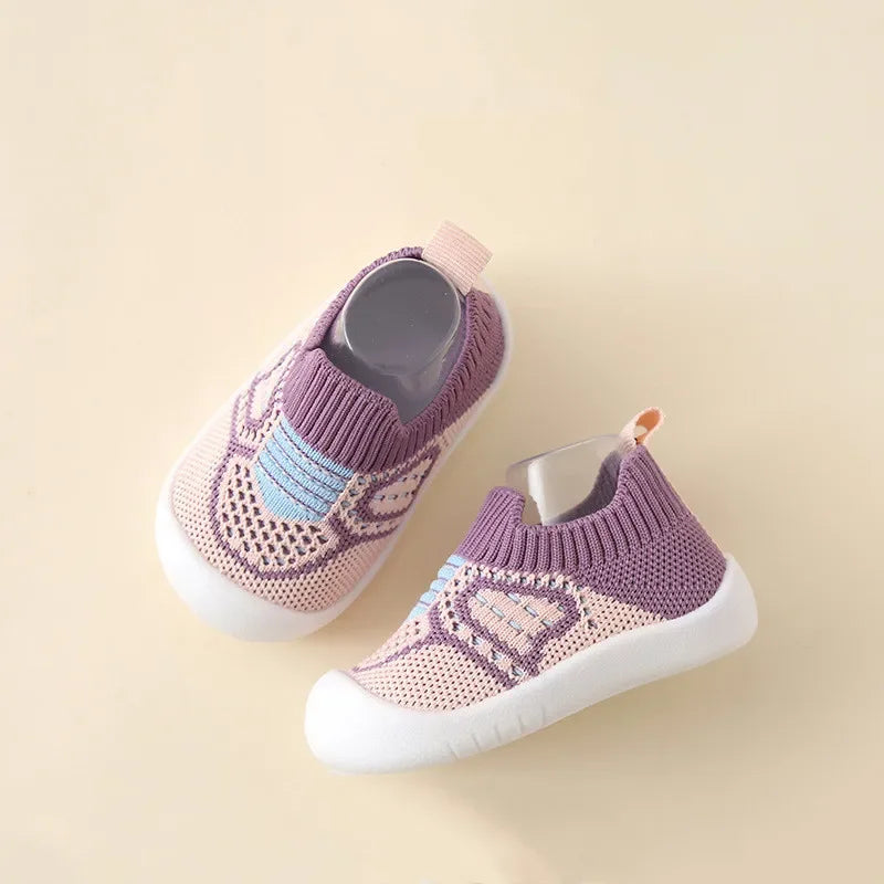 A pair of purple and pink breathable anti-slip baby first walker shoes with knitted texture.