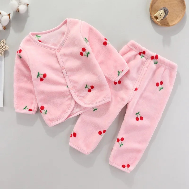 Pink fleece jacket and pants set for a baby with a cartoon print of red cherries