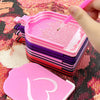 Pink diamond painting storage trays and organizer boxes with a pink brush being used on the tray