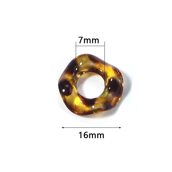 A close-up view of an amber and brown acrylic spacer bead with a 7mm height and 16mm length.