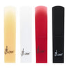 A set of four SLADE resin alto saxophone reeds in shades of yellow, white, red, and black.