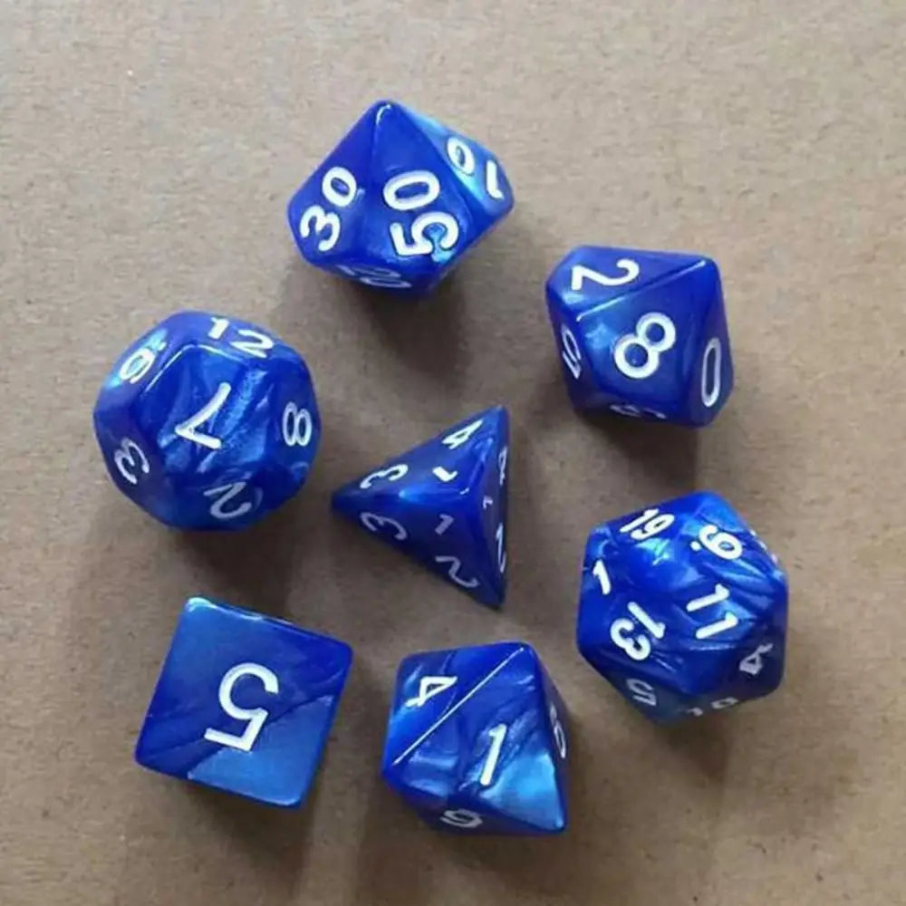 A collection of ten blue acrylic polyhedral dice scattered on a brown surface.