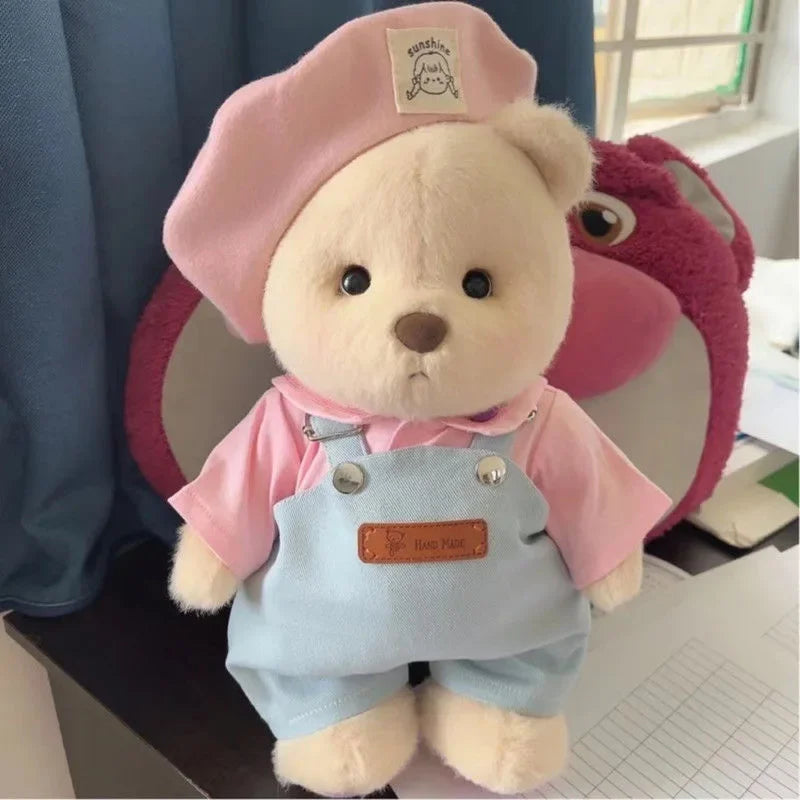 A fluffy teddy bear plush wearing a pink hat and a light blue apron.