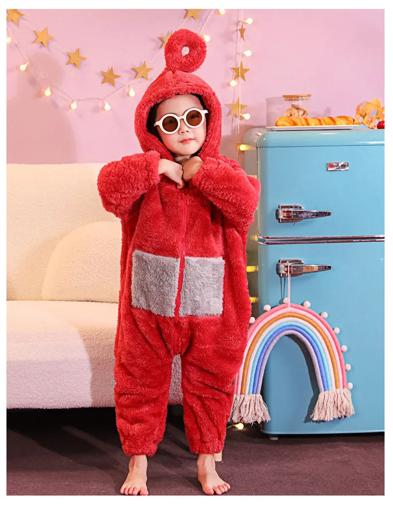 A child wearing a fuzzy red one-piece pajama costume with a hood and round glasses standing in front of a blue refrigerator.