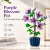 Purple Blossom Pot a small elegant display featuring a vibrant flower plant in a blue pot.
