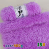 Purple chunky faux fur yarn in a skein and a ball, used for knitting projects.