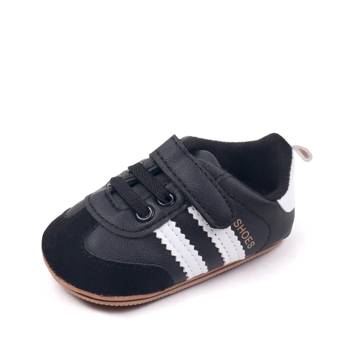 A pair of black and white baby first walkers shoes with soft soles.