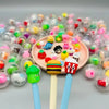 A collection of colorful plastic eggshell party favors in various shades and shapes scattered on a gray surface.