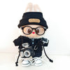 A Labubu doll wearing a black bear hoodie and headphones, with white laces on its feet.