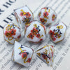 A set of milk white resin dice featuring a black kitten design with red floral accents.