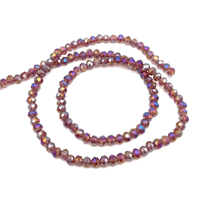 A strand of purple and pink faceted crystal beads for jewelry making