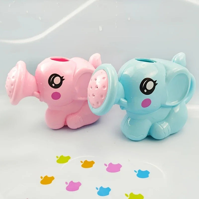 Two plastic elephant bath toys, one pink and one light blue, are shown on a white surface.