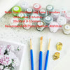 A collection of paint brushes and paint colors for a DIY sunflower paint by numbers kit.